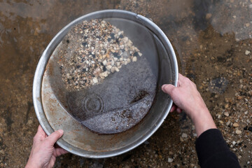 Panning for gold with a prospector's pan at Sovereign Hill tourist attraction in Ballarat, Victoria Australia - obrazy, fototapety, plakaty