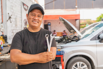 Portrait of a proud owner of an auto repair shop