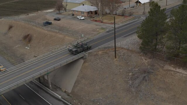 Beautiful old tank crossing overpass and entering neighborhood