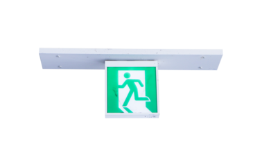 Fire exit green emergency exit signs isolated on cut out PNG or transparent background. Warning plate with running man icon. Fire escape sign hang on ceiling in the dark building near stairway.