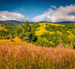 Wonderful morning scene of Rogojel village with haycocks. Bright summer view of Cluj County, Romania, Europe. Beauty of countryside concept background.. - 787834084