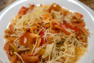 Som Tum, Thai papaya salad served on plate.