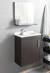 Sophisticated bathroom interior, a minimalist espresso vanity cabinet with an integrated white...