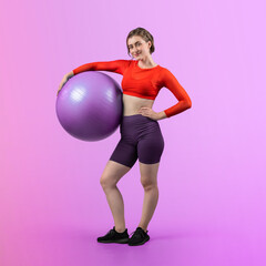 Full body length gaiety shot athletic and sporty young woman with fitness exercising ball in...