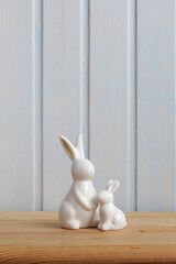 Easter bunnies, two white ceramic figurines on the table. Copy space.