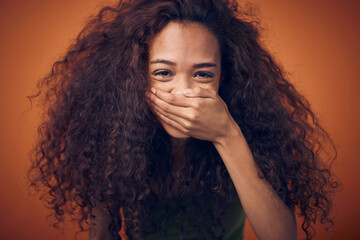 Hair, portrait and woman laughing in studio with funny, humor or joke on orange background....