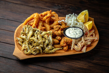 Plateau for a large company with different kinds of fish appetizers: fish sticks, fish, squid,...