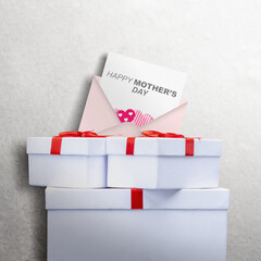 The letter with Happy Mother's Day text and a gift box - obrazy, fototapety, plakaty