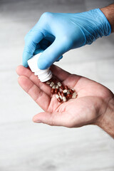 pills in the hands of the patient men - 787872669