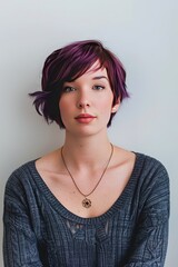 Young Woman With Vibrant Purple Hair Posing Against a Concrete Wall