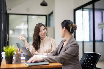 Smiling businesswoman listens attentively during a productive team meeting in a contemporary office setting.