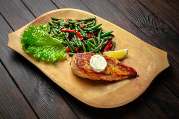 Chicken fillet with sesame seeds on dark boards background. Menu for a pub