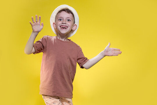 Portrait of a happy boy 6-7 years old on a yellow background, sea and summer