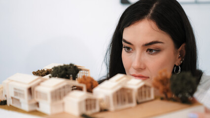 Cropped image of caucasian skilled architect engineer focus on checking architectural model....