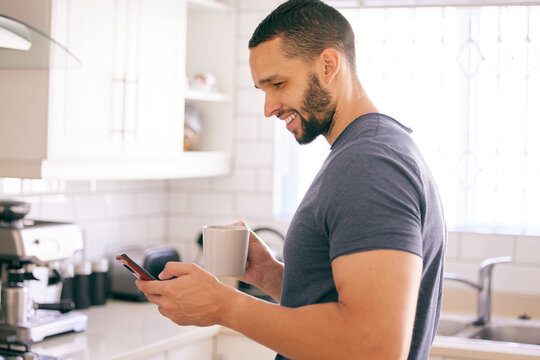 Home, coffee and man with smartphone, typing and connection with internet and latte in kitchen. Person in house, mobile user or guy with morning tea or cappuccino with cellphone, text or social media