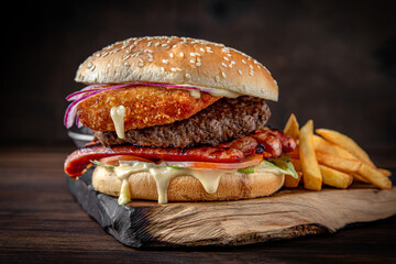 Burger with puffy beef patty, breaded cheese, iceberg lettuce. Juicy delicious hamburger on...