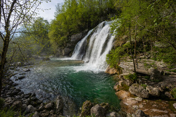 Obraz premium Bovec, Slovenia. Visje waterfalls. Nature trail crystal clear, turquoise water. easy trekking, nature experience, wood path. Waterfalls inside a forest, long photographic exposure, power of nature.