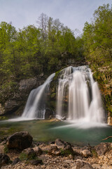 Fototapeta premium Bovec, Slovenia. Visje waterfalls. Nature trail crystal clear, turquoise water. easy trekking, nature experience, wood path. Waterfalls inside a forest, long photographic exposure, power of nature.