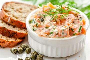 Salmon and cheese pate with bread and capers on white background