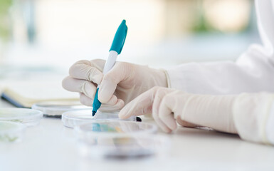 Research, writing and hands or scientist with pen to label petri dish for identification or analysis for tools. Person, zoom and marker in laboratory for innovation study, experiment and breakthrough