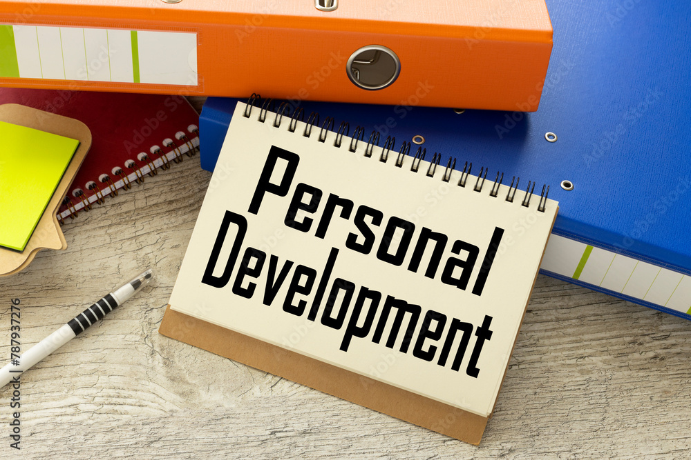 Poster personal development text on the page. notepad on paper folder