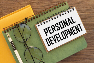 personal development yellow notepad and green notepad. text on page
