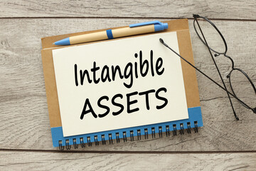 intangible assets . glasses on a notepad. top view of text