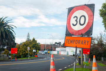 30km per hour road speed sign and orange traffic cones on the street. Roadworks in Auckland. - 787949494