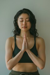Asian woman with prayer hands pose, or the prayer mountain pose.
