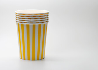 Pile of paper bucket with yellow stripes, empty popcorn buckets isolated on white background.