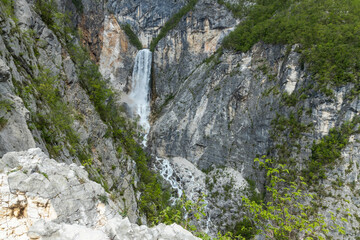 Boka waterfall in Slovenia, near Bovec. Easy trekking nature trail in the forest with the view of...