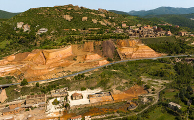 Aerial view of the former Monteponi mine, near Iglesias in Sardinia, Italy. The red color is due to...