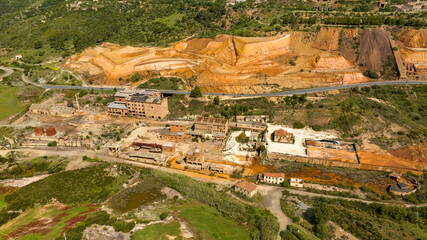 Aerial view of the former Monteponi mine, near Iglesias in Sardinia, Italy. The red color is due to the zinc and lead present in the soil. The mining plant is now closed. Mining concept.