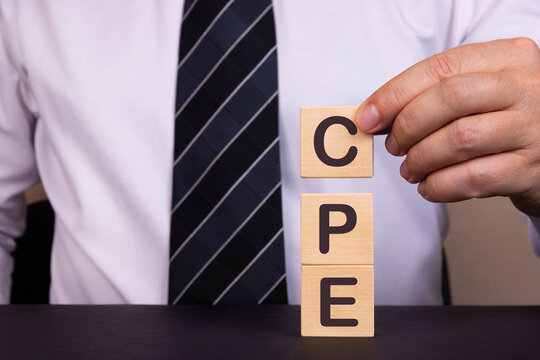 Man made word, text Acronym CPE Cost Per Engagement with wood blocks. Concept.