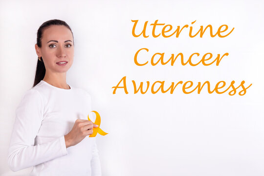 Female Doctor's Hand With Ribbon Showing Uterine Cancer Awareness