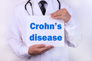 Doctor holding a card with Crohn's disease medical concept