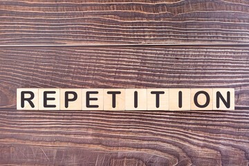 REPETITION word made with wood building blocks