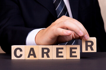 Obraz premium Man made word Career with wooden blocks. Business concept.