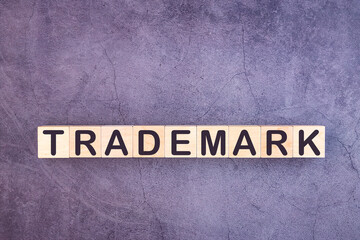 TRADEMARK word made with wood building blocks.