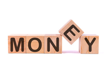 Word MONEY is made of wooden building blocks lying on the table and on a light background. Concept.