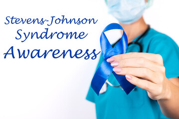 Stevens Johnson syndrome awareness: doctor in blue clothes with a blue ribbon in her hand