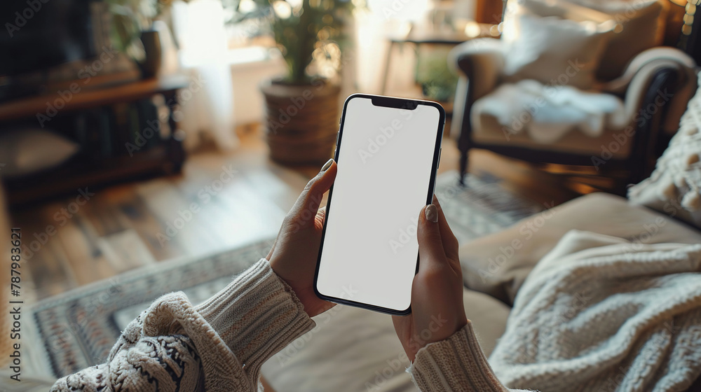 Poster mock-up a top-down view of a persons hands holding a smartphone with a blank screen. smartphone user