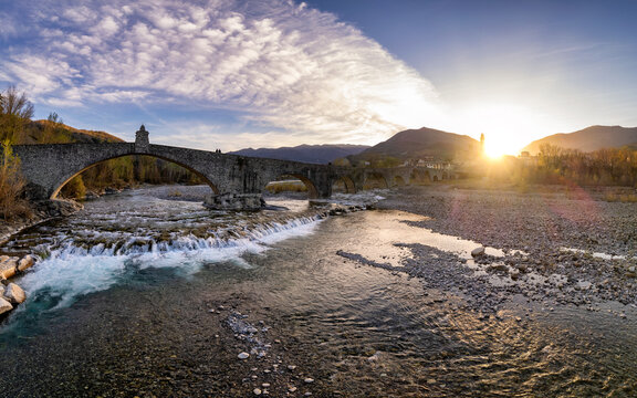 Aerial view of Bobbio and Devil's Bridge at sunset, Trebbia Valley, Emilia Romagna, Piacenza, Italy