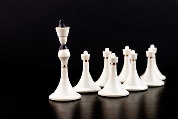 White chess pieces on a chessboard on a dark background. Business concept. Game, strategy, wisdom,...