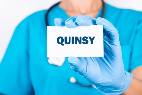 Doctor holding a card with text QUINSY, medical concept.