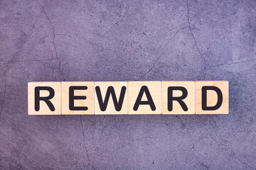 REWARD word made with wood building blocks.