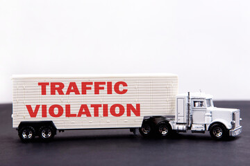 Traffic Violation word concept written on board a lorry trailer on a dark table and light background