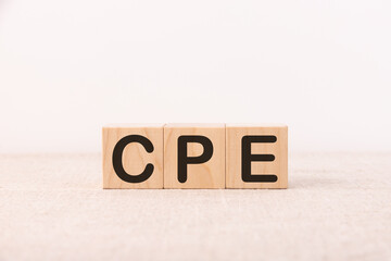 Word CPE Business Acronym Cost Per Engagement is made of wooden building blocks. Concept.