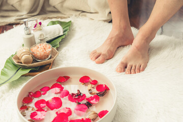 Woman indulges in blissful foot massage at luxurious spa salon while masseur give reflexology...