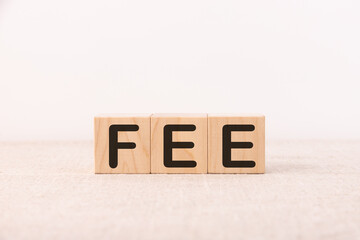 Word FEE is made of wooden building blocks. Concept.